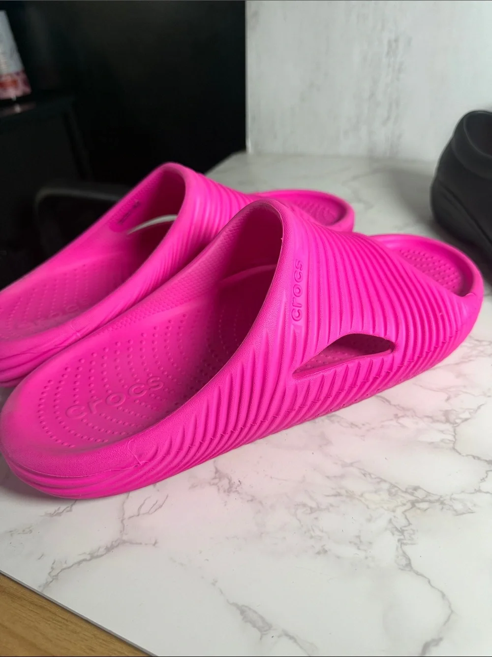 Two pairs of men’s size 11 crocs slides + black pair